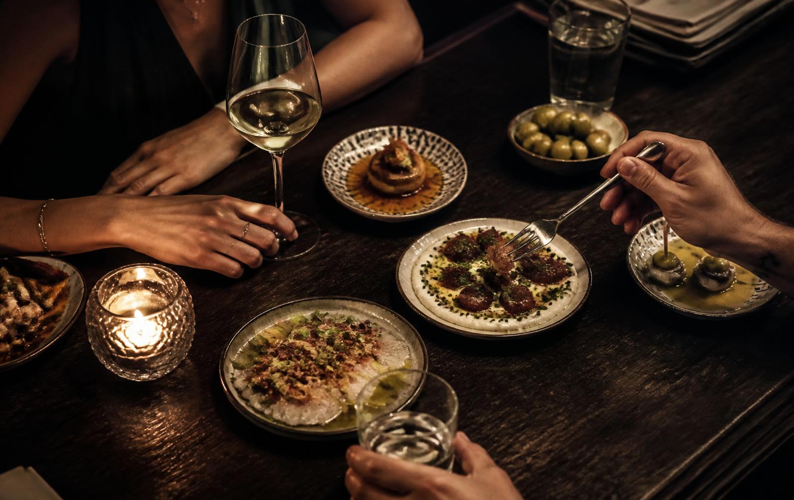 Creative sharing plates by candlelight in an intimate taberna