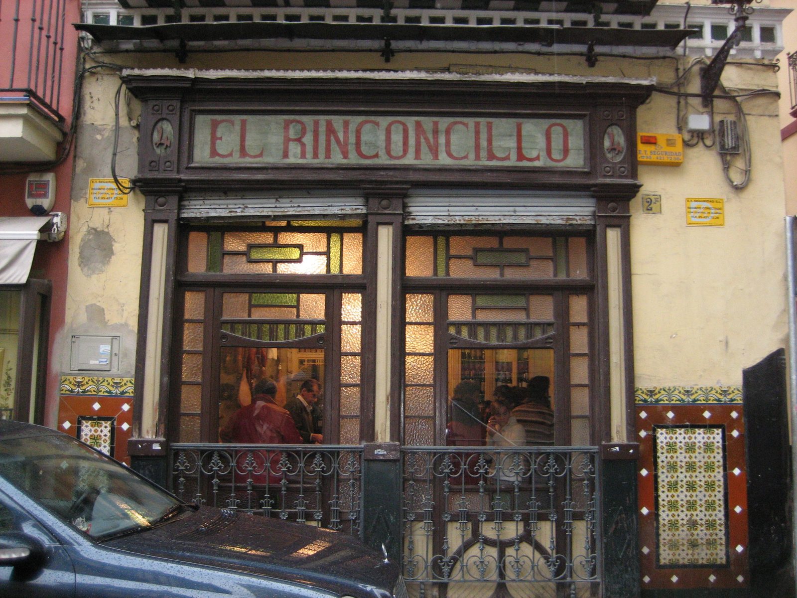 Facade of El Rinconcillo, the oldest tavern in Seville, with its stained glass and hand-painted sign