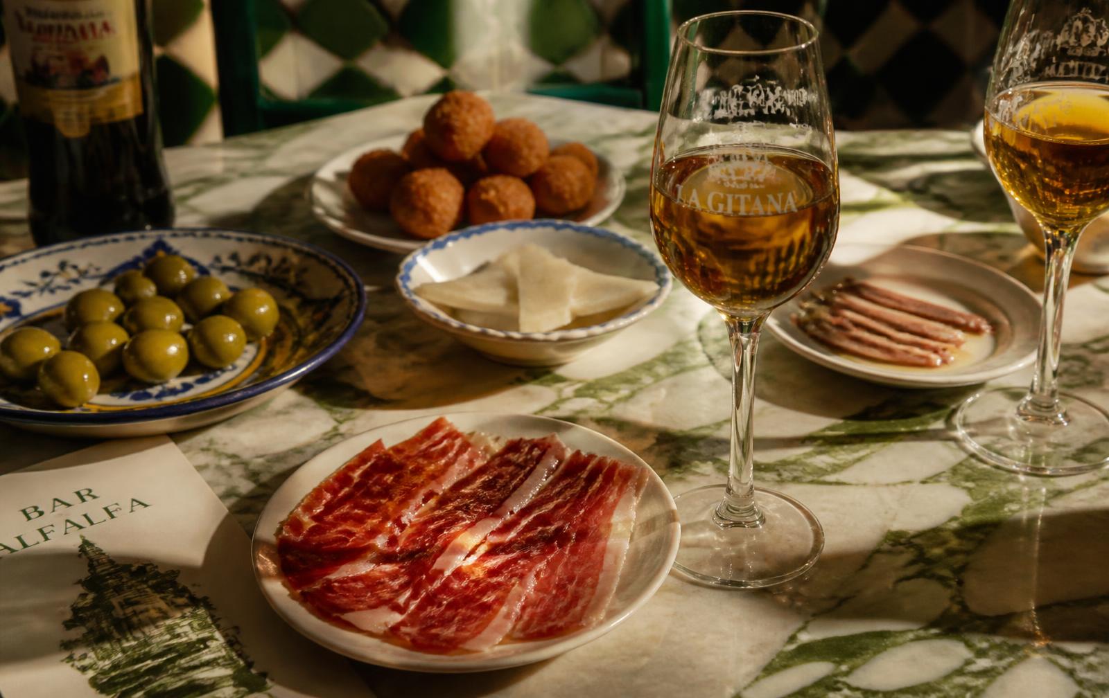 Andalusian tapas and sherry on a marble table in Seville